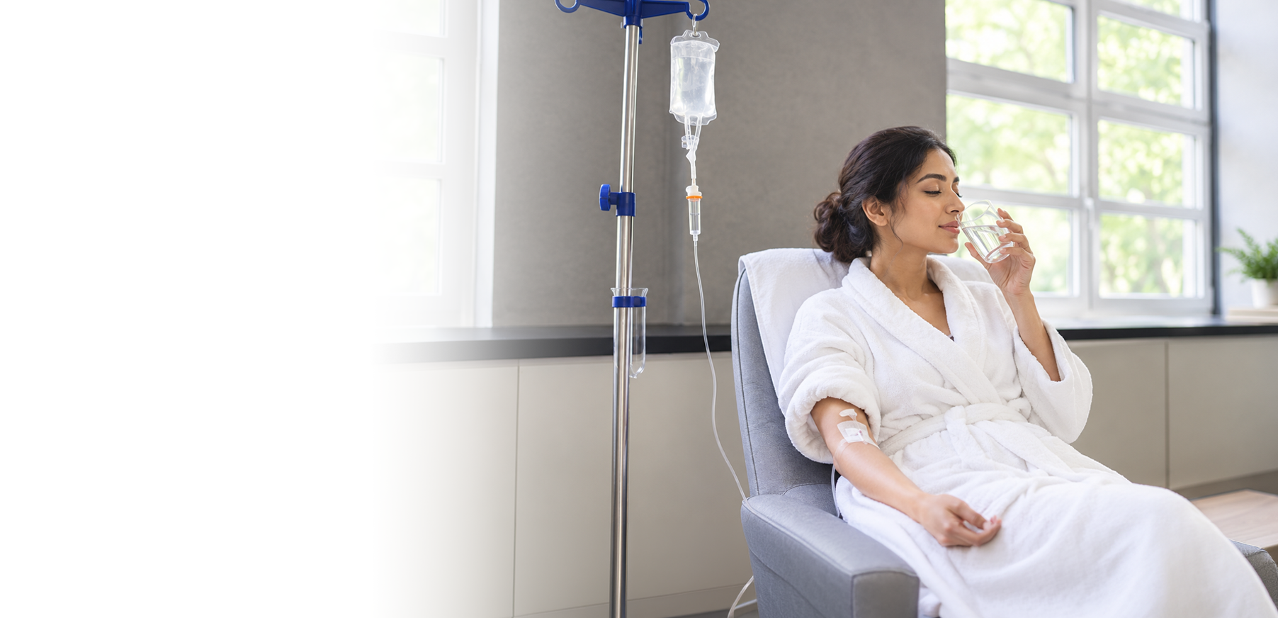 Patient relaxing in a robe while receiving an IV wellness drip at Dr. Nishita's clinic